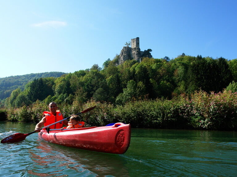 Kanufahrer auf der Wiesent mit Panorama der Neideck im Hintergrund